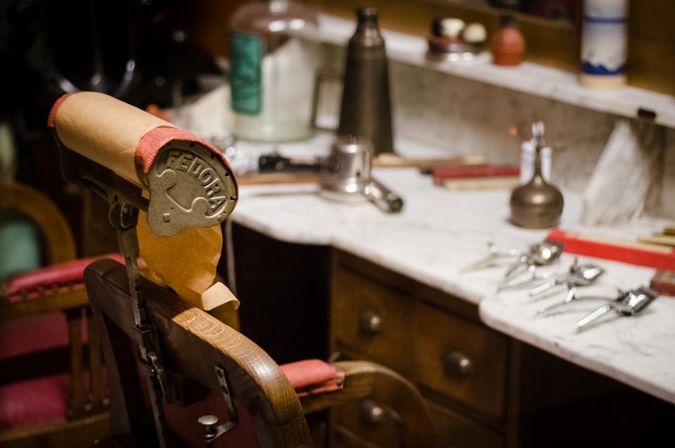 Vintage barber chair beside a marble counter of tools