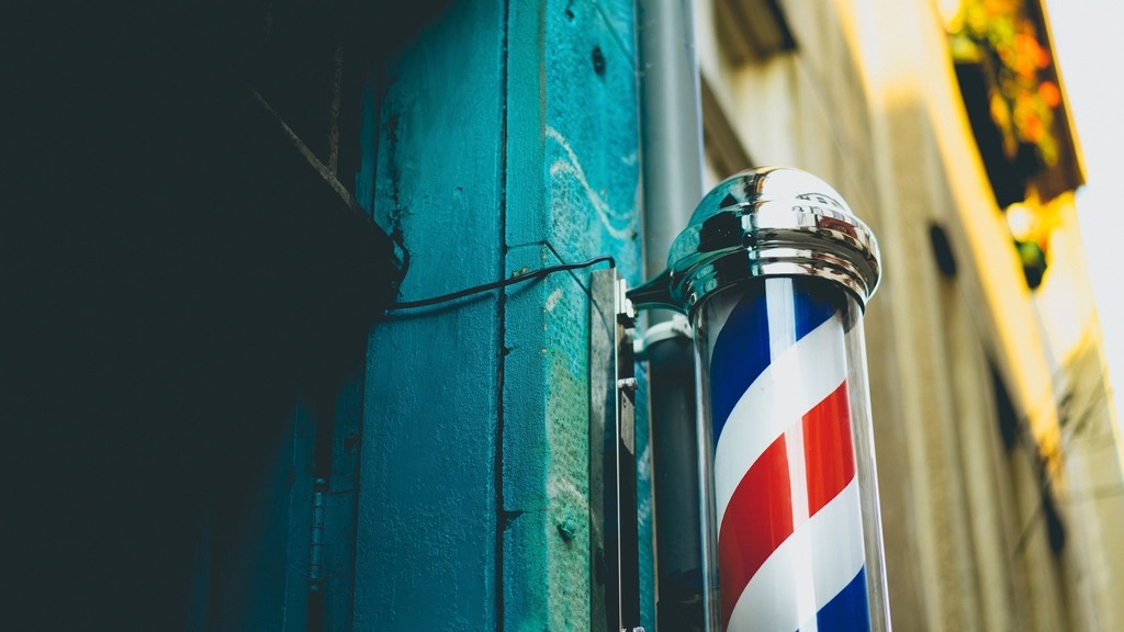 Spinning barber pole on a teal wall