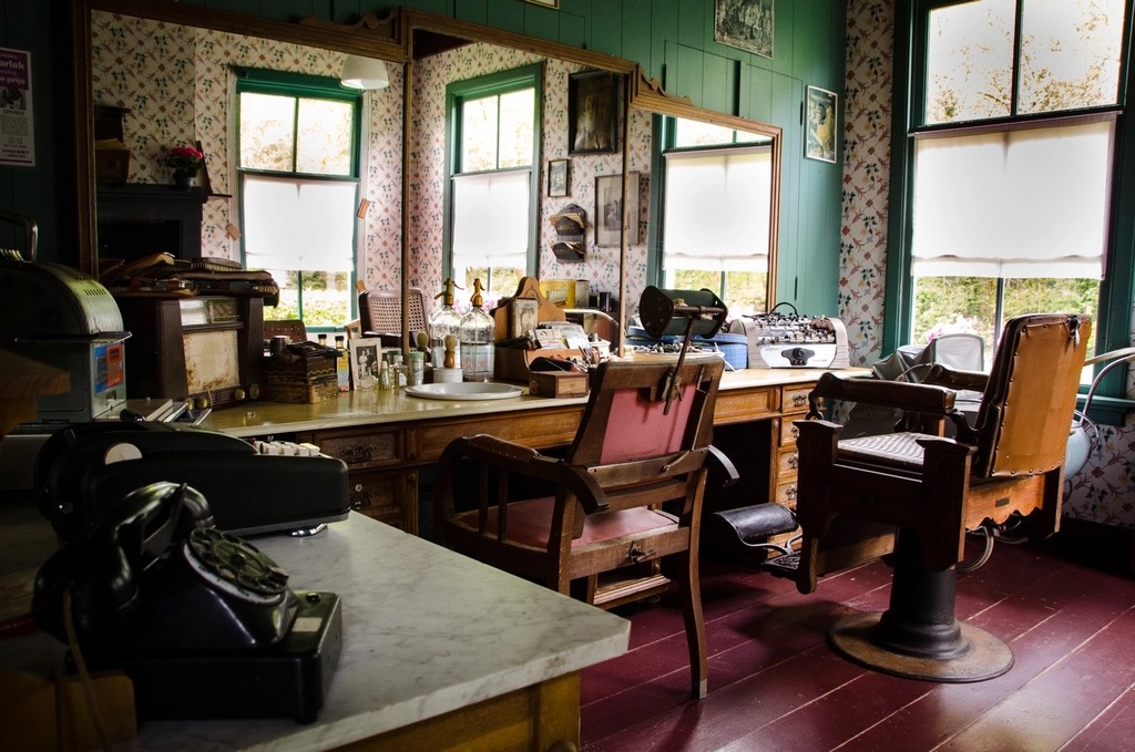 Inside a classic barbershop with leather chairs and a long counter