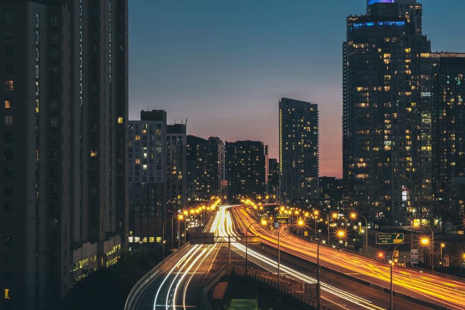 Towers at dusk above a busy road