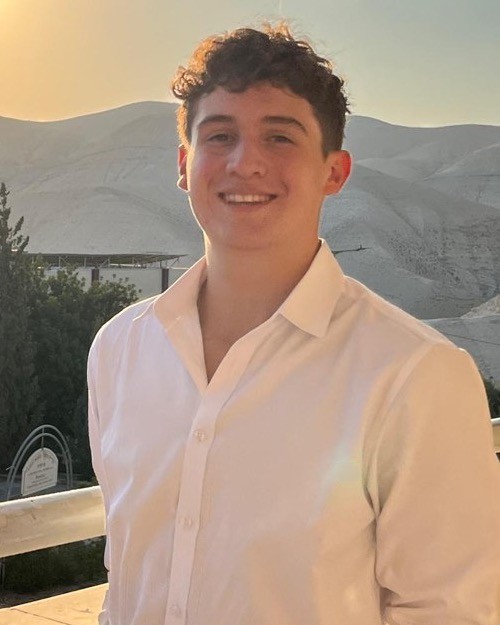 Yosef Yavner, founder of Yosef Designs, smiling outdoors at sunset